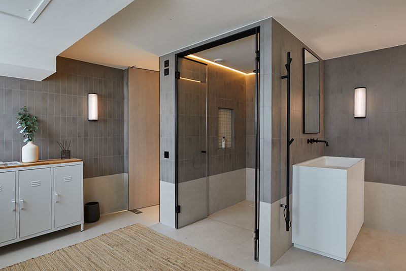 Shower room with tiled walls, walk-in glazed shower and freestanding basin