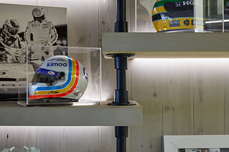 Illuminated display shelving with racing memorabilia and helmets