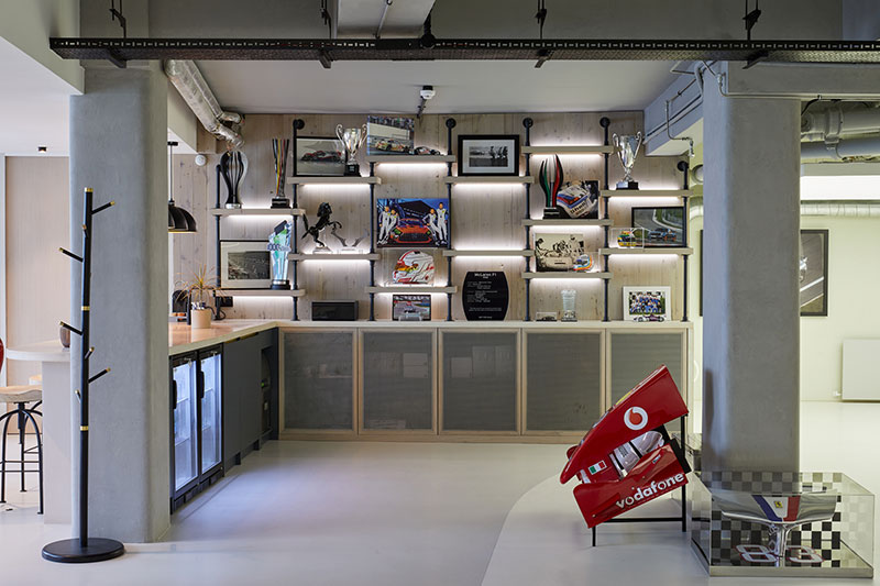 Bespoke joinery and lit display wall beside the bar and kitchenette